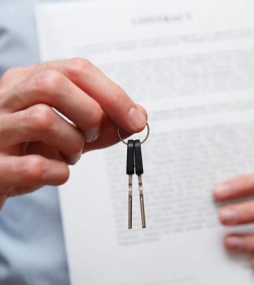 Businessman offering a key with contract. Rental agreement with contract.
